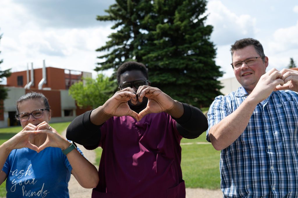 Volunteer giving a box with donations to another volunteer